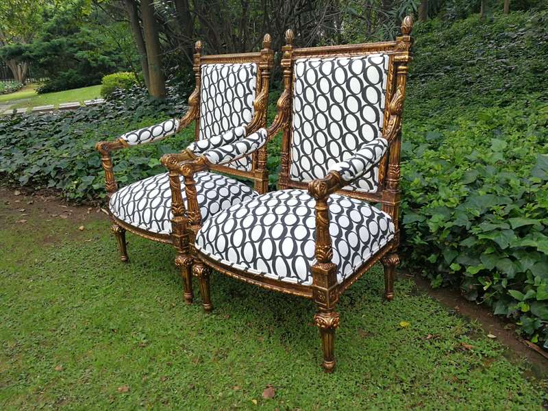 A Pair of French Style Ornately Carved and Gilded Armchairs ND
