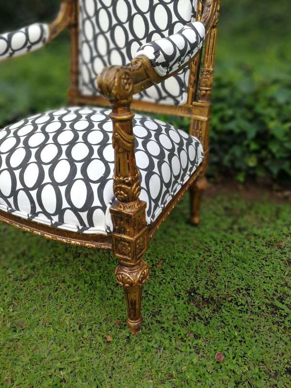 A Pair of French Style Ornately Carved and Gilded Armchairs ND