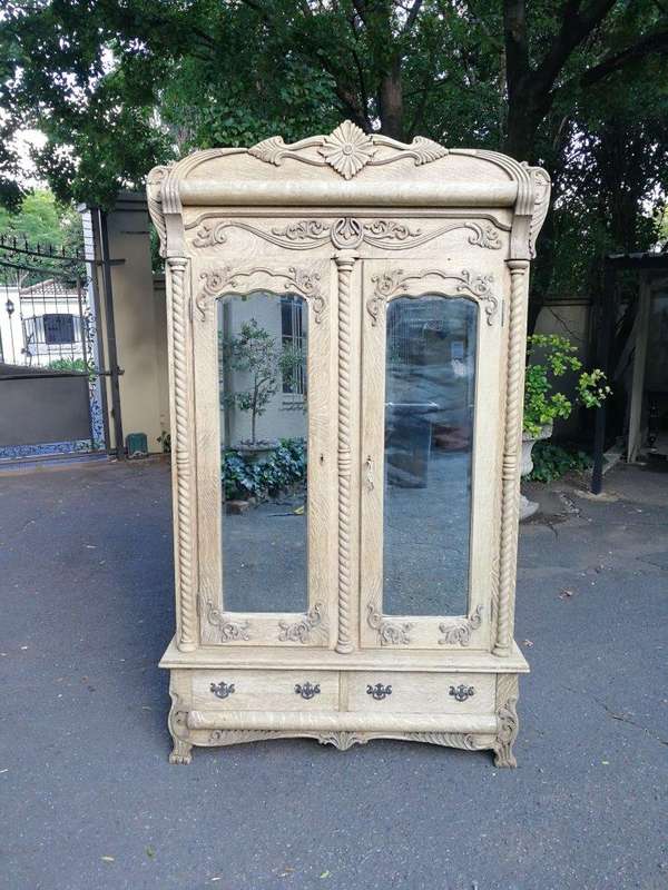 An Antique Victorian English Carved And Bleached Oak Armoire With Bevelled Mirror Doors And Two D...