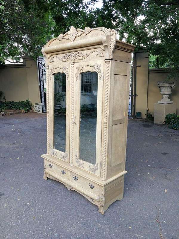 An Antique Victorian English Carved And Bleached Oak Armoire With Bevelled Mirror Doors And Two D...