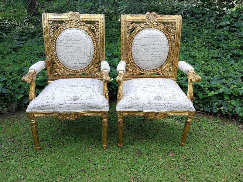 A 20TH Century Pair Of Ornately Carved And Hand Gilded French Style Armchairs Upholstered in a Cu...