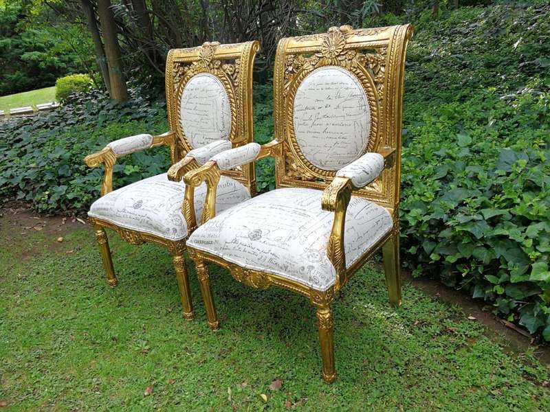 A 20TH Century Pair Of Ornately Carved And Hand Gilded French Style Armchairs Upholstered in a Cu...