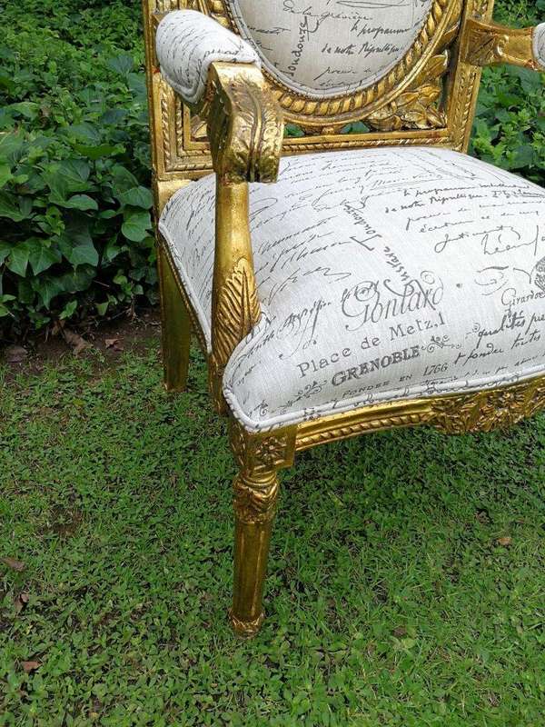 A 20TH Century Pair Of Ornately Carved And Hand Gilded French Style Armchairs Upholstered in a Cu...