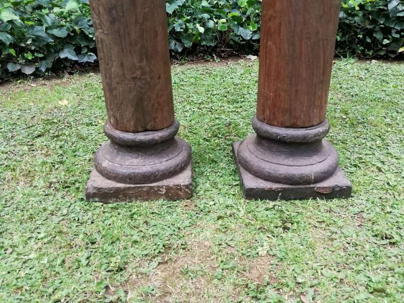 An Antique Pair Of Teak Pillars With Stone Bases