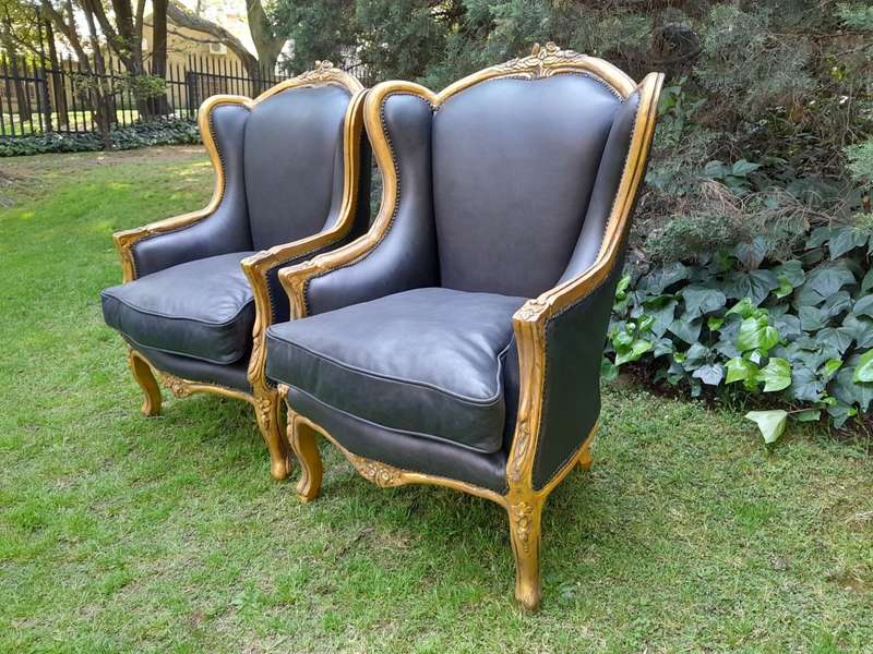 A Pair of French Style Hand Gilded Armchairs Upholstered in Leather