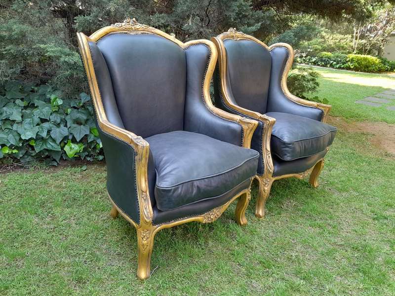 A Pair of French Style Hand Gilded Armchairs Upholstered in Leather