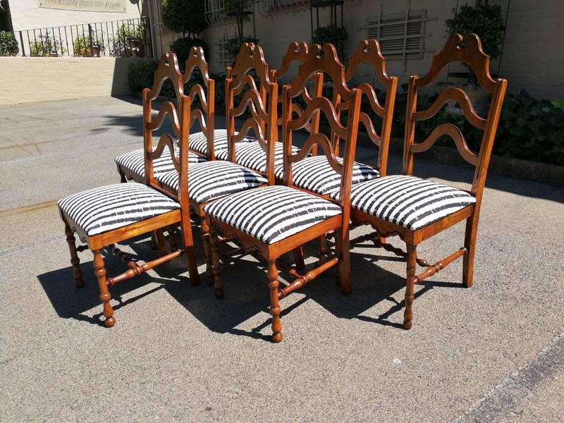 A Set Of Eight Carved Dining Chairs