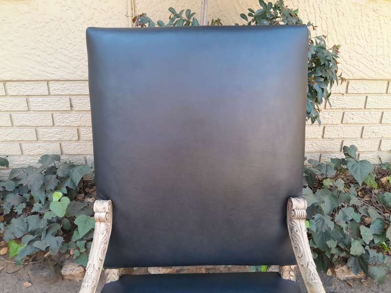 An Antique Ornately Carved Oak Throne Armchair Upholstered in Leather and in a Contemporary Bleac...