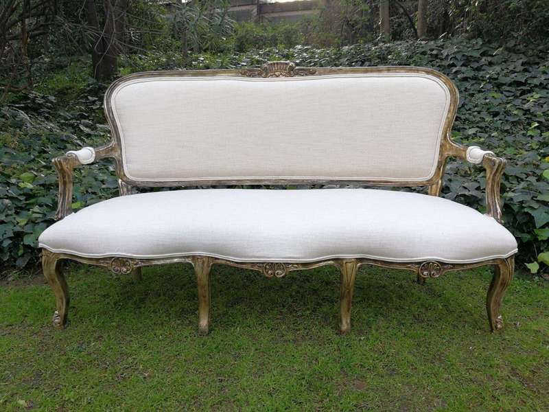 A 20th Century Carved And Hand-Gilded French Style Settee Upholstered In An Imported Linen
