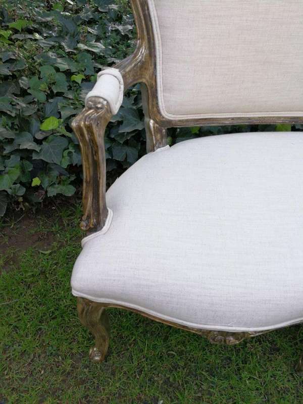 A 20th Century Carved And Hand-Gilded French Style Settee Upholstered In An Imported Linen