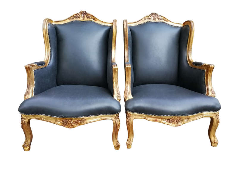 A 20th Century Pair Of French Style Carved And Gilded Armchairs in Leather