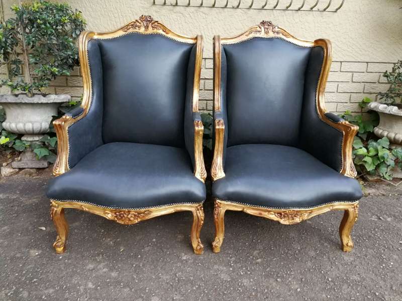 A 20th Century Pair Of French Style Carved And Gilded Armchairs in Leather