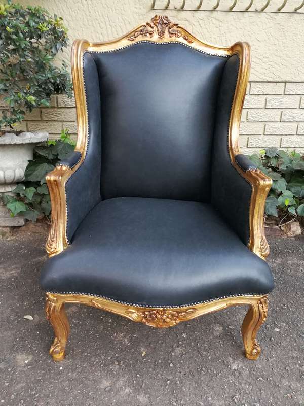 A 20th Century Pair Of French Style Carved And Gilded Armchairs in Leather