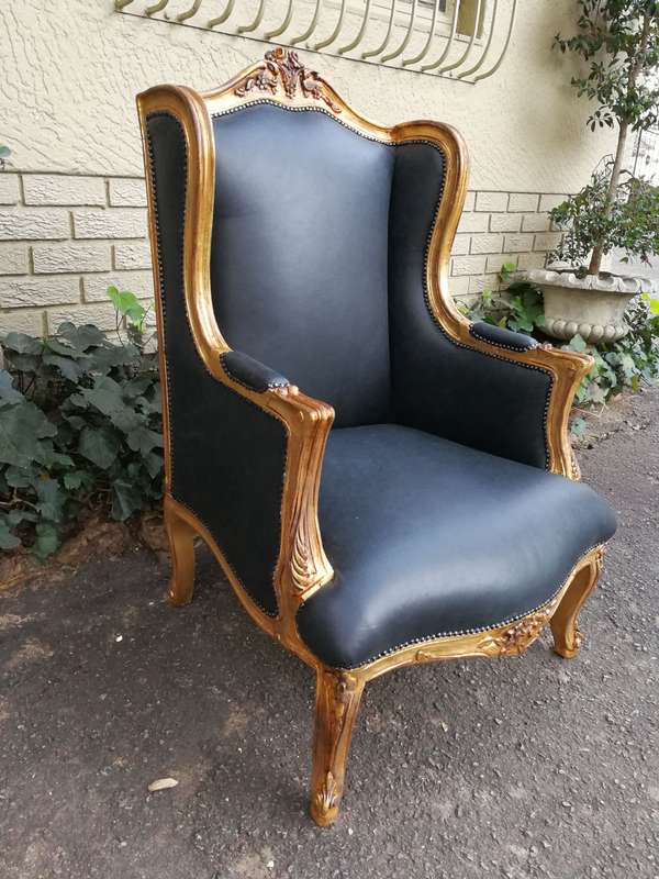 A 20th Century Pair Of French Style Carved And Gilded Armchairs in Leather