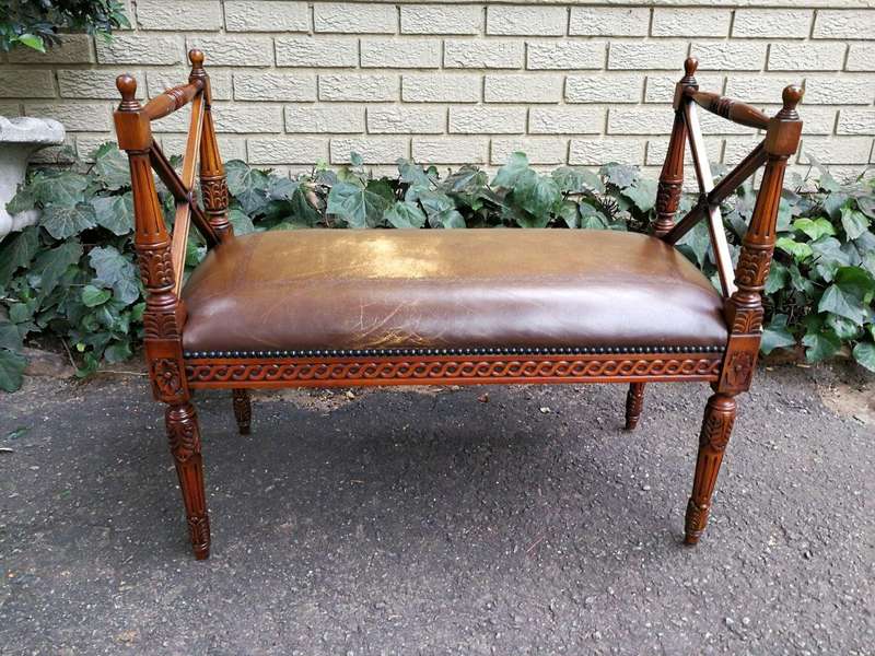 A 20th Century French Carved Mahogany Ottoman With Gilt Tooled Brown Leather