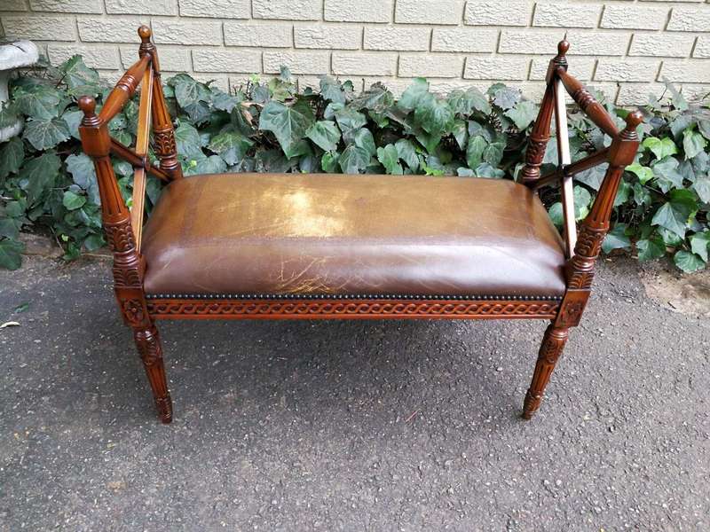 A 20th Century French Carved Mahogany Ottoman With Gilt Tooled Brown Leather