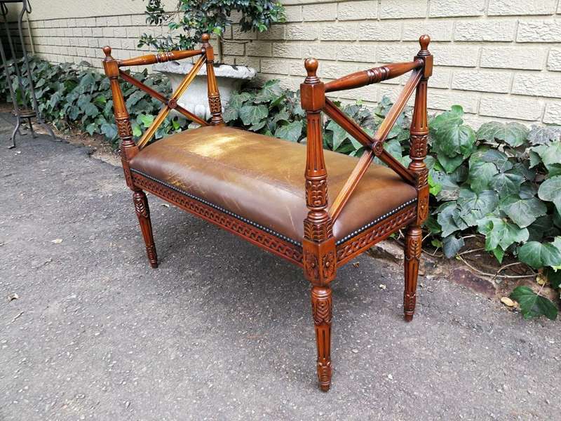 A 20th Century French Carved Mahogany Ottoman With Gilt Tooled Brown Leather