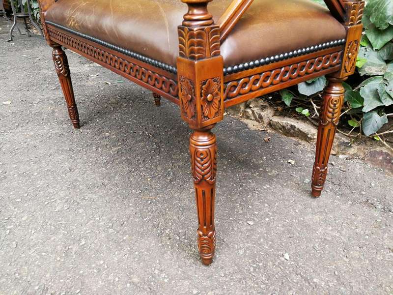 A 20th Century French Carved Mahogany Ottoman With Gilt Tooled Brown Leather
