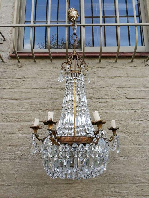 A 20th Century French Style Empire Brass and Crystal Chandelier