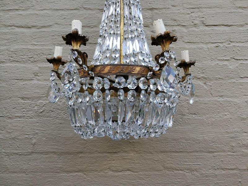 A 20th Century French Style Empire Brass and Crystal Chandelier