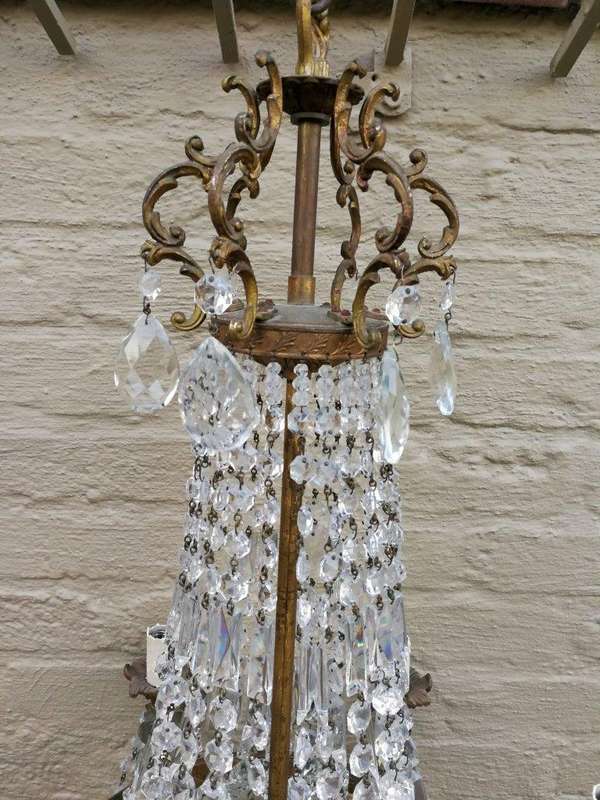 A 20th Century French Style Empire Brass and Crystal Chandelier