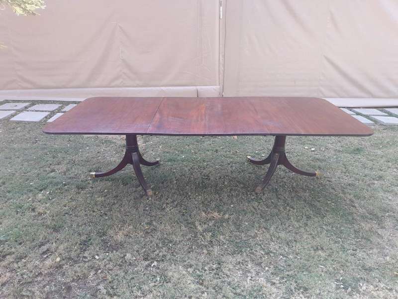 A 20th Century Mahogany Dining Table with Two Extensions and Brass Feet & Casters