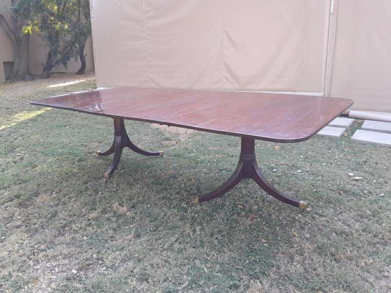 A 20th Century Mahogany Dining Table with Two Extensions and Brass Feet & Casters