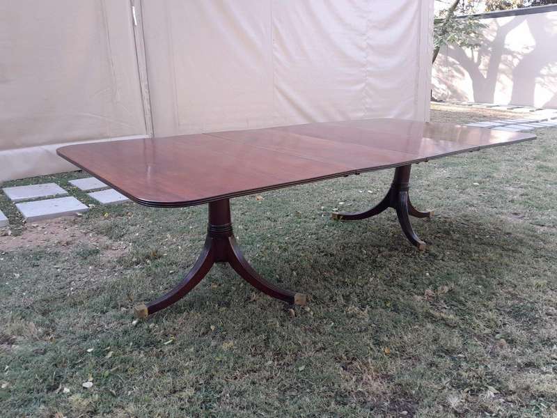A 20th Century Mahogany Dining Table with Two Extensions and Brass Feet & Casters