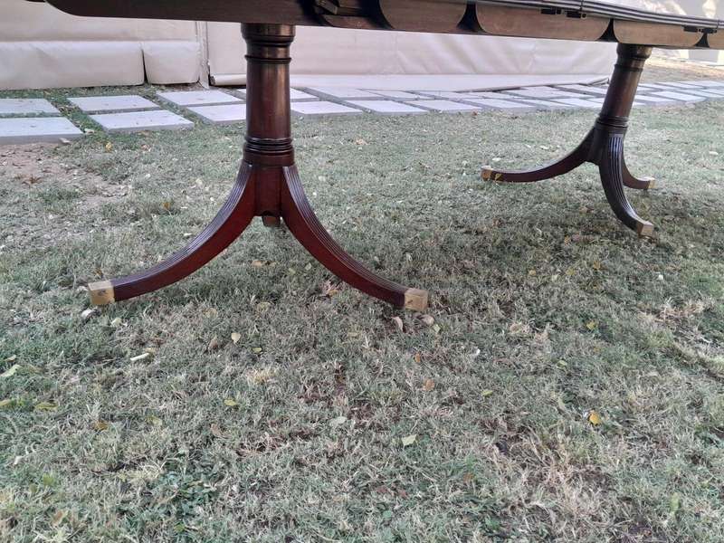 A 20th Century Mahogany Dining Table with Two Extensions and Brass Feet & Casters