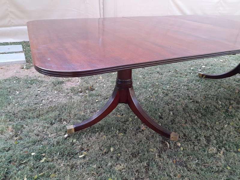 A 20th Century Mahogany Dining Table with Two Extensions and Brass Feet & Casters