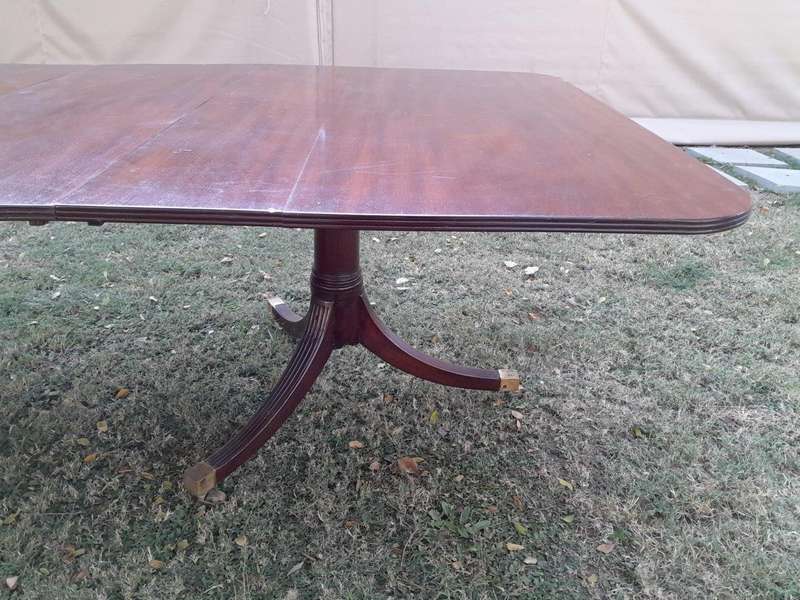 A 20th Century Mahogany Dining Table with Two Extensions and Brass Feet & Casters