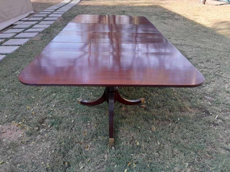 A 20th Century Mahogany Dining Table with Two Extensions and Brass Feet & Casters