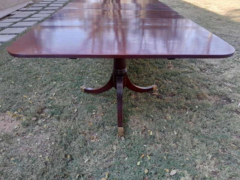 A 20th Century Mahogany Dining Table with Two Extensions and Brass Feet & Casters