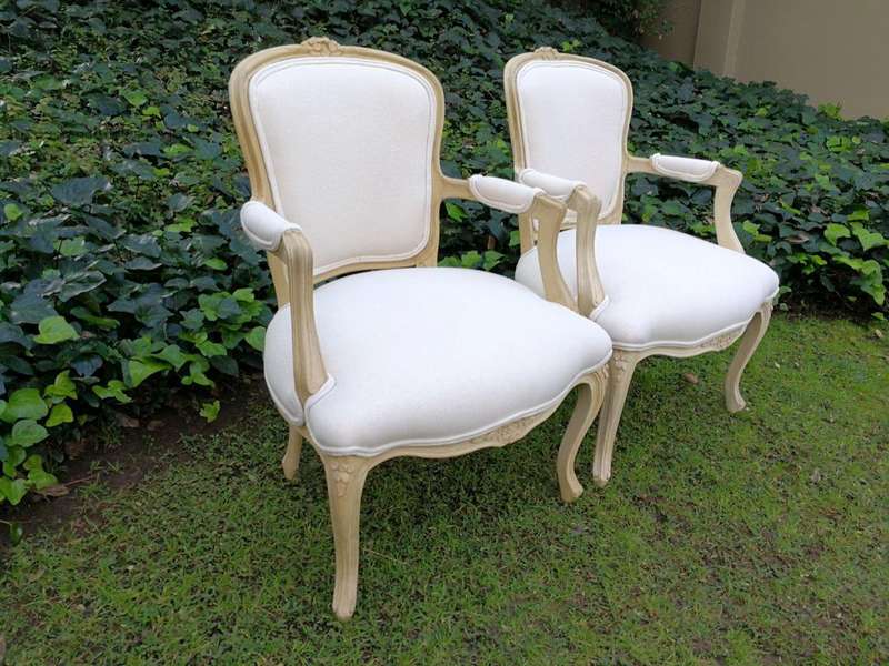A Pair of 20th Century French Rococo Style Oak Armchairs in a bleached / natural finish