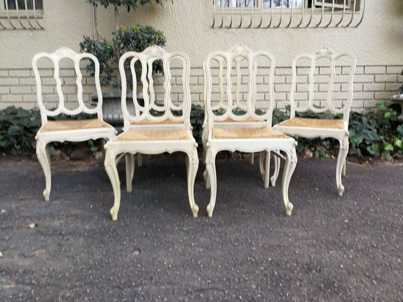 A 20TH Century French Set of Six Carved Dining Chairs with Rush Seats in a Contemporary Bleached ...