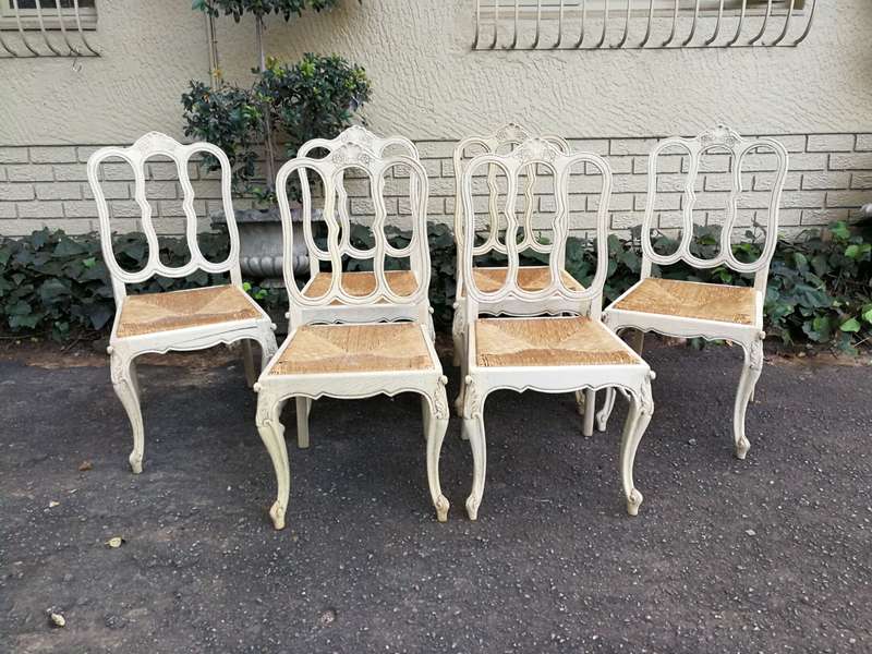 A 20TH Century French Set of Six Carved Dining Chairs with Rush Seats in a Contemporary Bleached ...