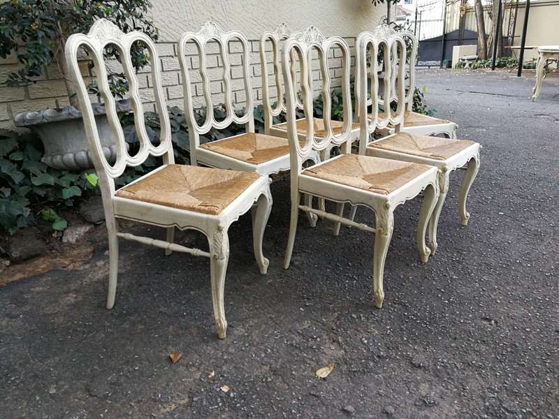 A 20TH Century French Set of Six Carved Dining Chairs with Rush Seats in a Contemporary Bleached ...