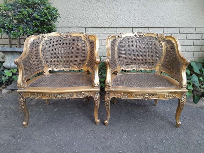 A 20th Century Pair or French Bergere Style Carved and Hand Gilded in Gold Leaf Wooden Chairs