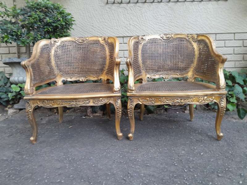 A 20th Century Pair or French Bergere Style Carved and Hand Gilded in Gold Leaf Wooden Chairs