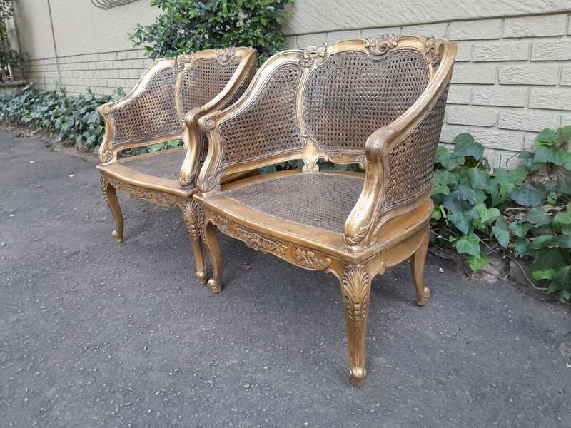 A 20th Century Pair or French Bergere Style Carved and Hand Gilded in Gold Leaf Wooden Chairs
