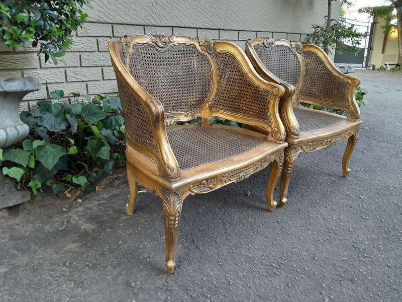 A 20th Century Pair or French Bergere Style Carved and Hand Gilded in Gold Leaf Wooden Chairs