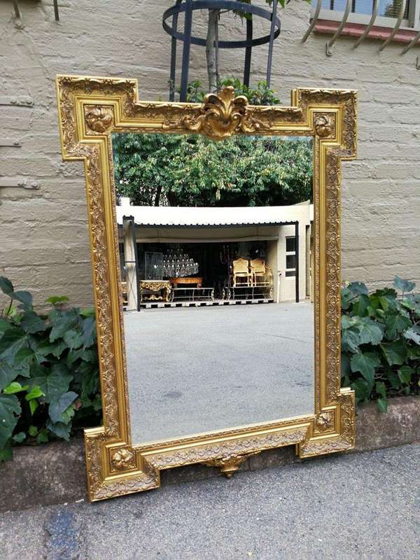 A Highly Carved and Ornate French-style Gilt and Bevelled Mirror