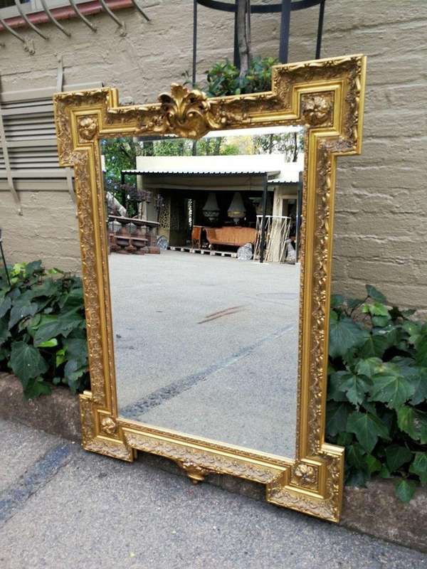 A Highly Carved and Ornate French-style Gilt and Bevelled Mirror