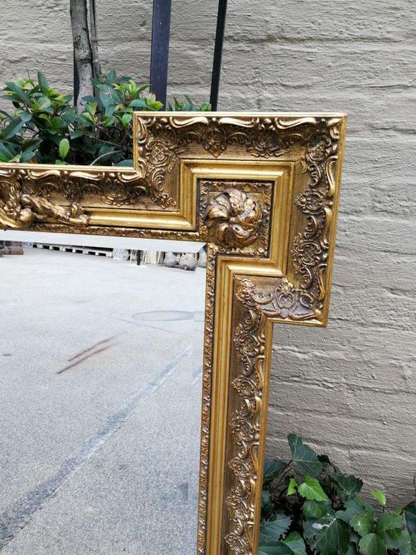A Highly Carved and Ornate French-style Gilt and Bevelled Mirror