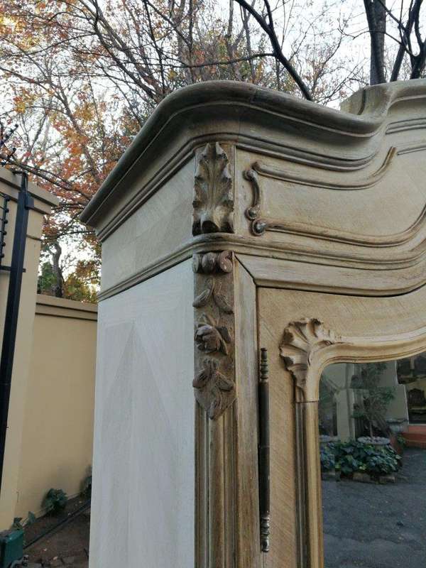 A 19th Century French Rococo Armoire In A Bleached Contemporary Finish With Bevelled Mirrors