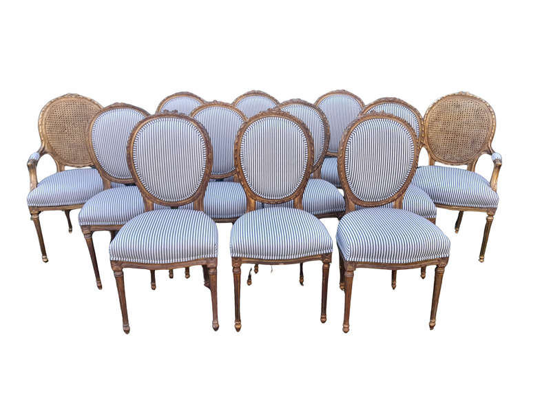 A 20th Century French Style Imported Set Of Twelve Gilded Dining Chairs Comprising: Two Carvers  ...