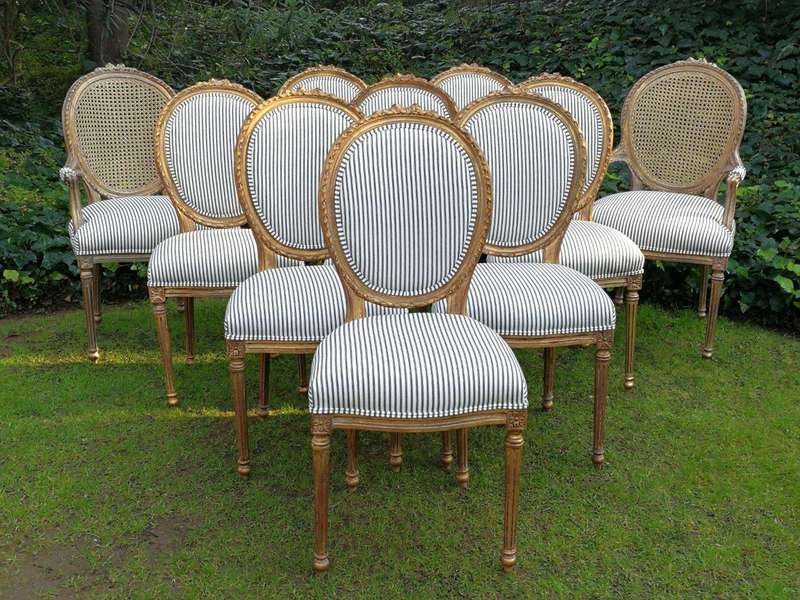 A 20th Century French Style Imported Set Of Twelve Gilded Dining Chairs Comprising: Two Carvers  ...
