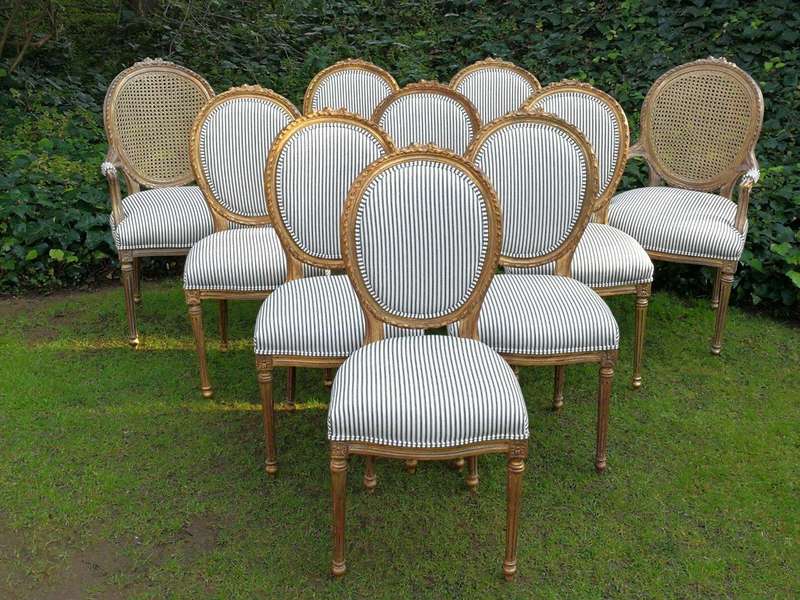 A 20th Century French Style Imported Set Of Twelve Gilded Dining Chairs Comprising: Two Carvers  ...