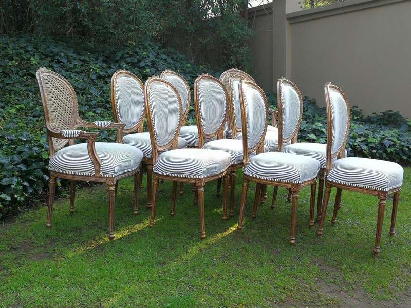 A 20th Century French Style Imported Set Of Twelve Gilded Dining Chairs Comprising: Two Carvers  ...
