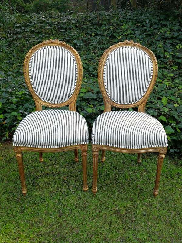 A 20th Century French Style Imported Set Of Twelve Gilded Dining Chairs Comprising: Two Carvers  ...